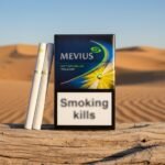 ซองบุหรี่ Mevius Option Blue Yellow สีน้ำเงินเหลือง วางบนท่อนไม้แห้ง ฉากหลังเป็นทะเลทรายสีทองและท้องฟ้าสดใส