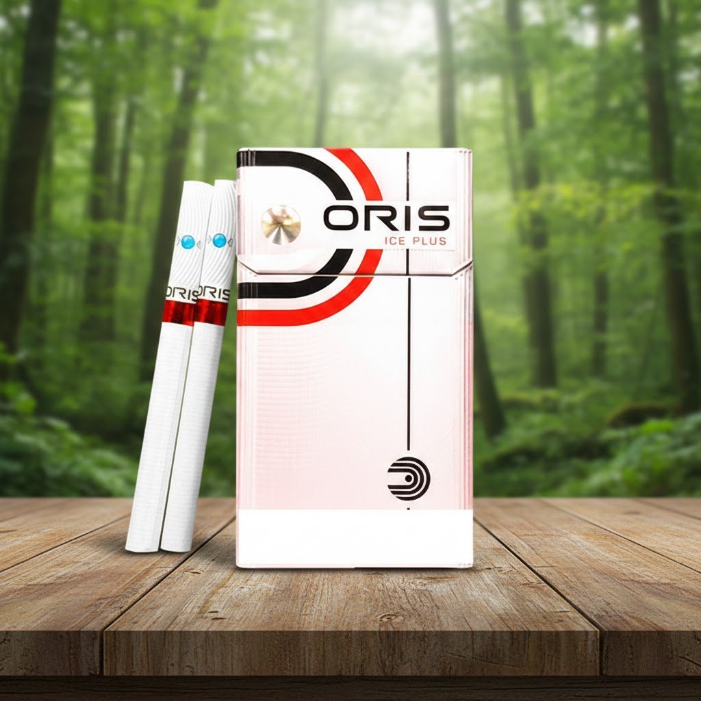 ซองบุหรี่ Oris Intense Ice Plus สีขาวแถบดำแดง พร้อมมวนบุหรี่ 1 เม็ดบีบ วางบนโต๊ะไม้ในป่า
