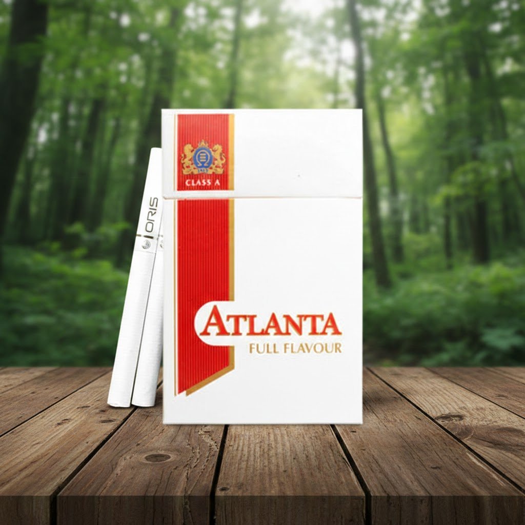 ซองบุหรี่ Atlanta Red Full Flavour สีขาวคาดแดง ดีไซน์คลาสสิก วางบนโต๊ะไม้ท่ามกลางบรรยากาศป่าธรรมชาติ
